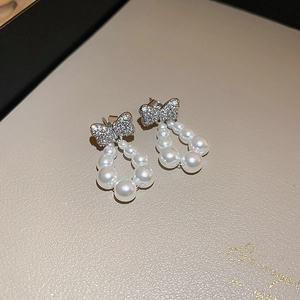 Elegant silver bow earrings with sparkling cubic zirconia and dangling imitation pearls