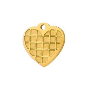 Macro shot of gold stainless steel heart pendant with checkered grid texture