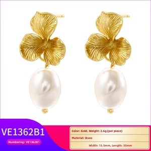 Detailed view of gold petal earrings with white rice pearls and precise 35mm dimensions