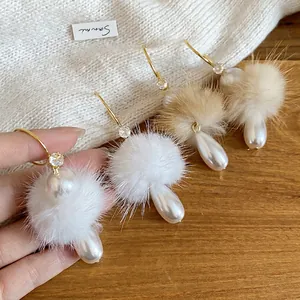 Elegant C-shaped pearl earrings with mink fur balls and gold accents for women