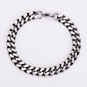 Close-up of dual-tone 9mm Cuban link bracelet with matte and polished steel finish