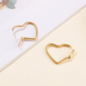 Golden heart-shaped hoop earrings featuring a stylish twisted rope texture for women