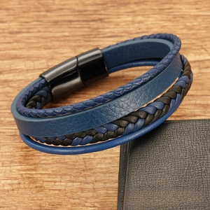 Detail of multi-layer blue and black woven leather bracelet with a black magnetic clasp