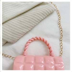 Detailed top view of pink quilted PVC jelly bag with elegant gold chain strap detail