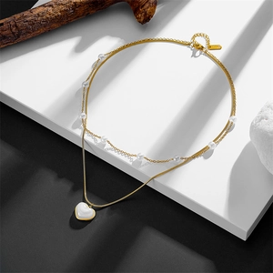Detail of S925 titanium double-layer necklace with gold beads, pearls and heart pendant