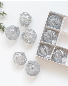 Détails de boules de Noël argentées avec paillettes et perles dans leur boîte blanche