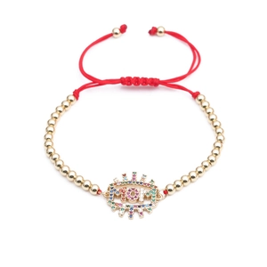 Detail of red braided MOM bracelet featuring gold beads and colorful cubic zirconia stones