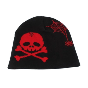 Detailed close-up of knit beanie featuring red skull and spider web jacquard patterns