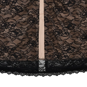 Close-up of intricate black floral lace fabric with beige lining and scalloped edge detail