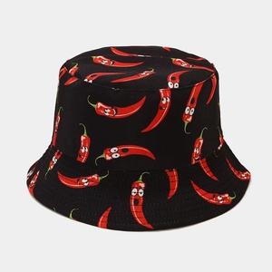 Close-up of funny cartoon chili patterns and stitching on a black cotton bucket hat