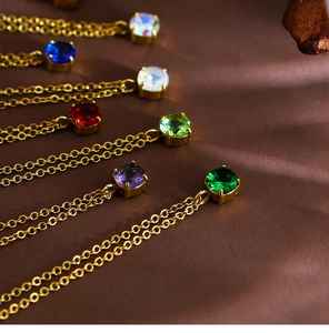 Detailed close-up of colorful round-cut birthstone pendants with gold-plated steel chains