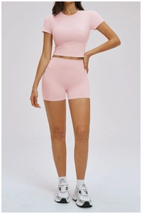 Detailed shot of pink high-waist fitness shorts and cropped top for yoga training