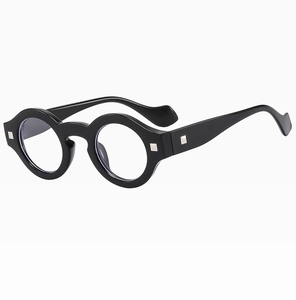 Detailed view of black round sunglasses with silver rivets and wavy temple design