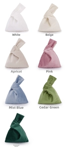 Detailed array of colorful velvet knot wrist bags showing various elegant fabric textures