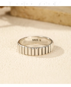 Macro shot of S925 sterling silver ring featuring vertical textured grooves on stone base