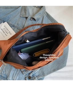 Top view showing a spacious interior of a brown canvas tote bag with various daily essentials