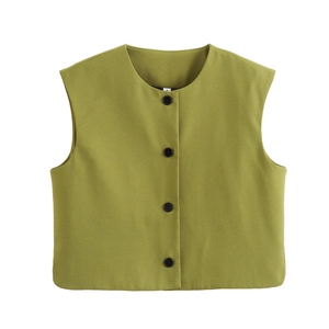 Detailed view of women's green vest with V-neck, button closure, and rich fabric texture