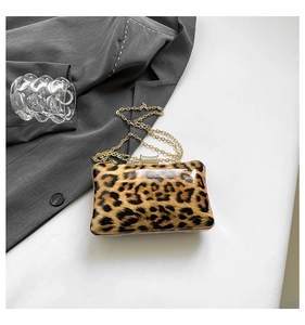 Flat lay showing details of a leopard print evening clutch bag with gold chain strap