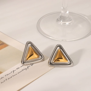 Detailed view of geometric triangular stud earrings with gold and silver two-tone metal finish