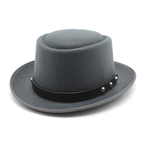 Détail du chapeau en laine grise avec bande en cuir noir et rivets métalliques argentés