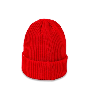 Detail of red ribbed knit beanie showing thick vertical texture and folded cuff style