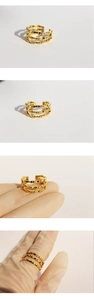 Macro detail showing three-layered bamboo design of the golden adjustable open ring