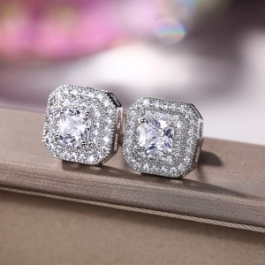 Macro shot of silver square double halo stud earrings featuring sparkling cubic zirconia