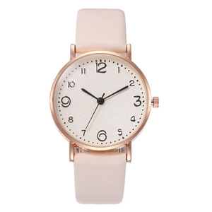 Detail of a ladies watch with a rose gold case, white dial, and pink leather strap
