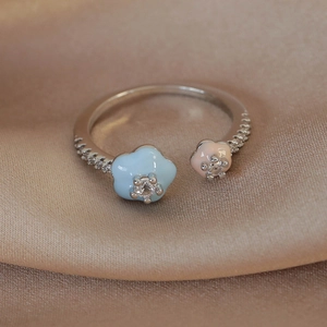 Detailed close-up of macaron flower ring with zircon inlays and colorful enamel finish