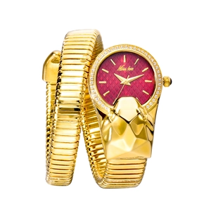 Detail of a luxury gold snake-shaped watch with red dial and crystal-embellished bezel