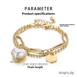 Detailed macro view of a gold stainless steel double chain bracelet with heart pendant