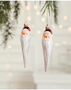 Close-up of Santa Claus hanging ornaments with glitter texture on pine tree branches