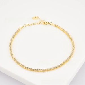 Detail of s925 silver gold chain bracelet with round zircon stones and adjustable clasp