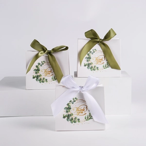 Minimalist white wedding favor gift bags with eucalyptus leaf design and thank you print