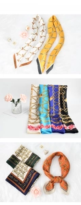 Detail view of retro equestrian chain pattern silk scarves in vibrant colors