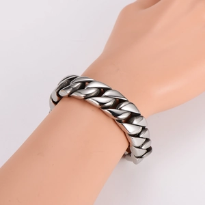 Mens thick silver stainless steel cuban chain bracelet shown on a hand model