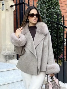 Détail du manteau en laine grise avec col en fausse fourrure luxueuse et poignets assortis