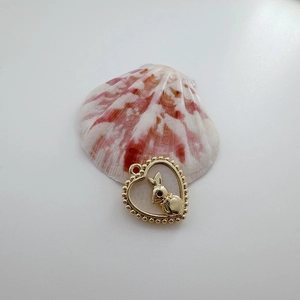 Close-up of 18K gold-plated heart rabbit charm with hollow design and beaded edges