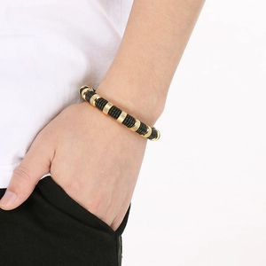 Men's woven black and gold stainless steel bracelet with knurled industrial metal beads