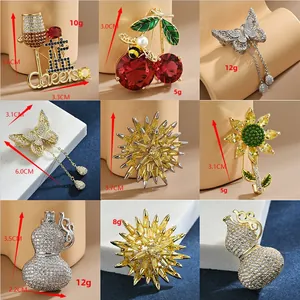 Macro display of diverse micro-pave brooches including cherry, butterfly and gourd designs
