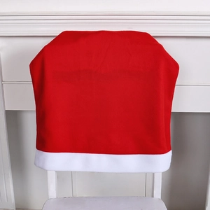 Red Christmas hat chair cover with white border placed on a white chair backrest