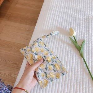 Detail of waffle texture cotton handbag with yellow tulip pattern and soft carry handle