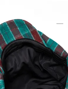 Detailed macro view of the soft cotton sweatband and plaid fabric on the duckbill cap