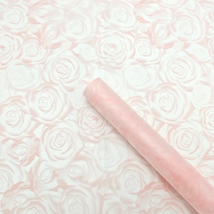 Detail view of waterproof pink rose flower bouquet wrapping paper in a neat roll form