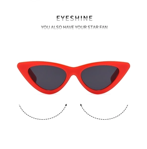 Front view of trendy red cat-eye sunglasses for kids with dark lenses on white background