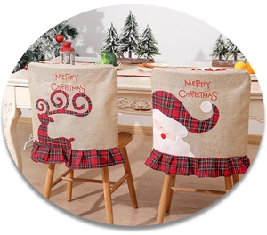 Detailed embroidery of Santa and reindeer on linen dining chair covers for Christmas decor