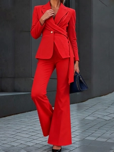 Modern red two-piece suit with slim-fit blazer and flared trousers for professional women