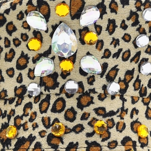 Macro detail of leopard print fabric with various rhinestones on a bridal police hat