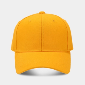 Front view of solid bright yellow cotton twill baseball cap with curved brim on white background