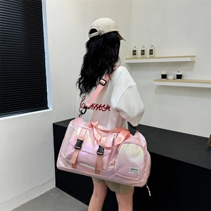 Detail of pink pearlescent waterproof fitness bag with buckle and adjustable shoulder strap
